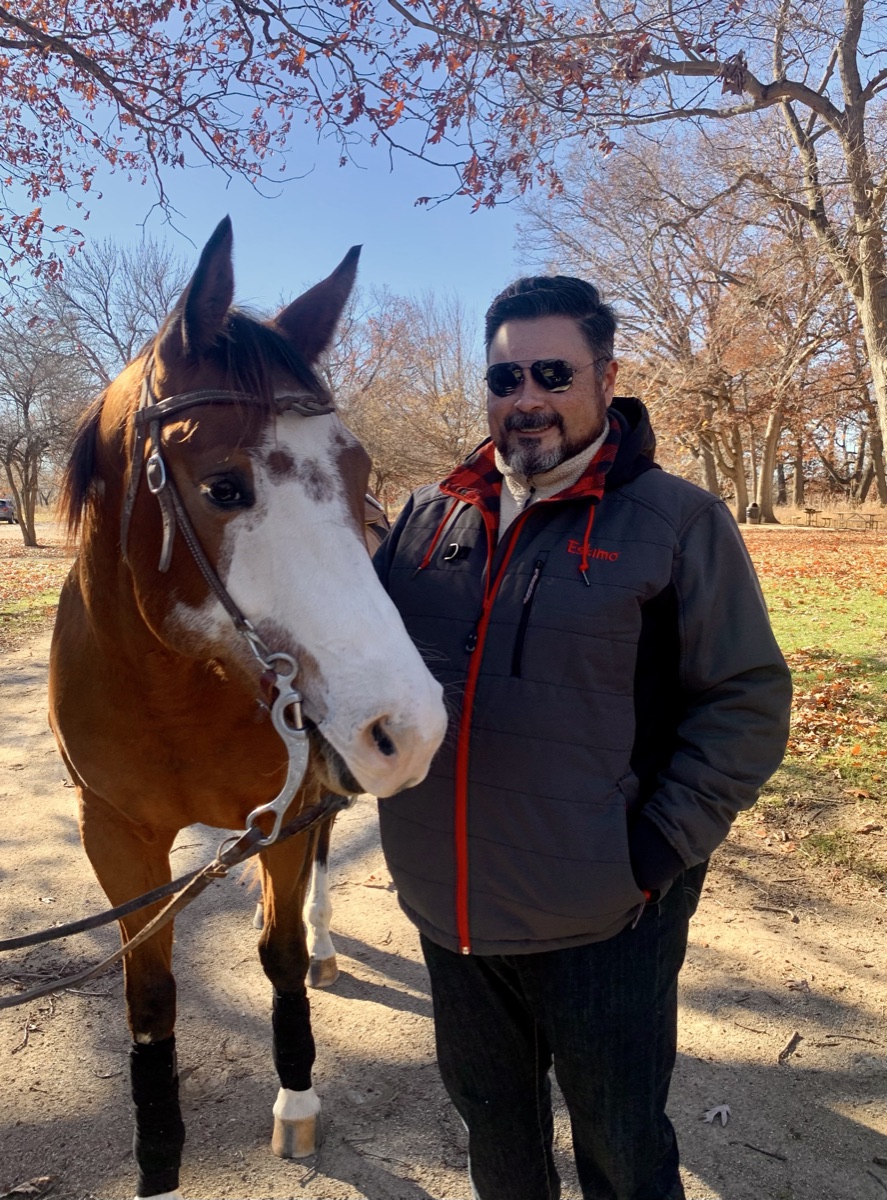 Jose Martinez with a horse on a Lake County forest preserve trail