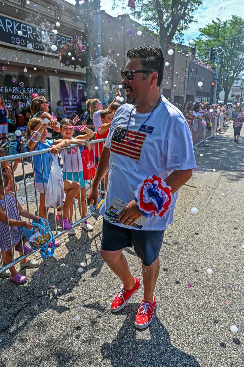 Jose Martinez greeting families along the route at the Antioch 4th of July parade