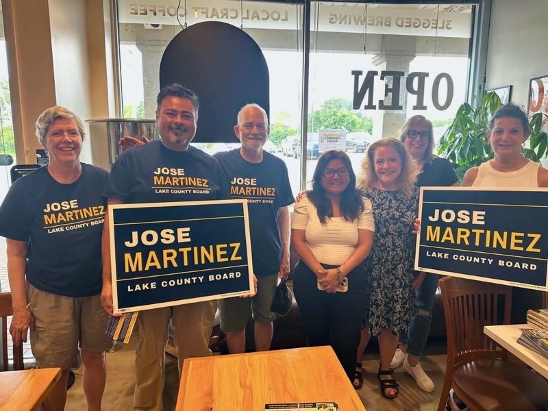 Jose Martinez with supporters holding campaign signs at a coffee meet and greet at 3Legged Brewing in Antioch, Lake County, Illinois